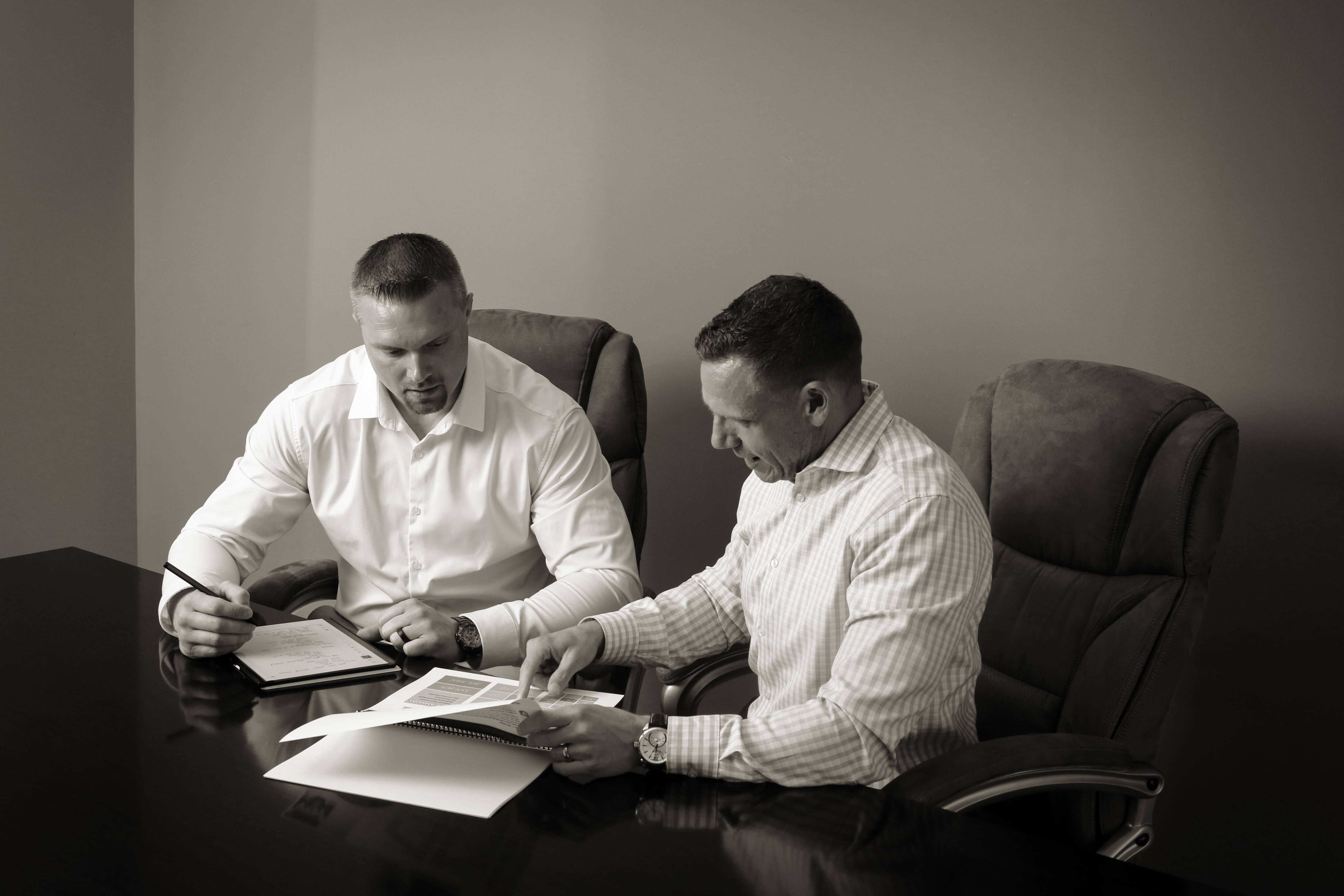 Tailored Wealth Solutions advisors presenting investment plan in client meeting room